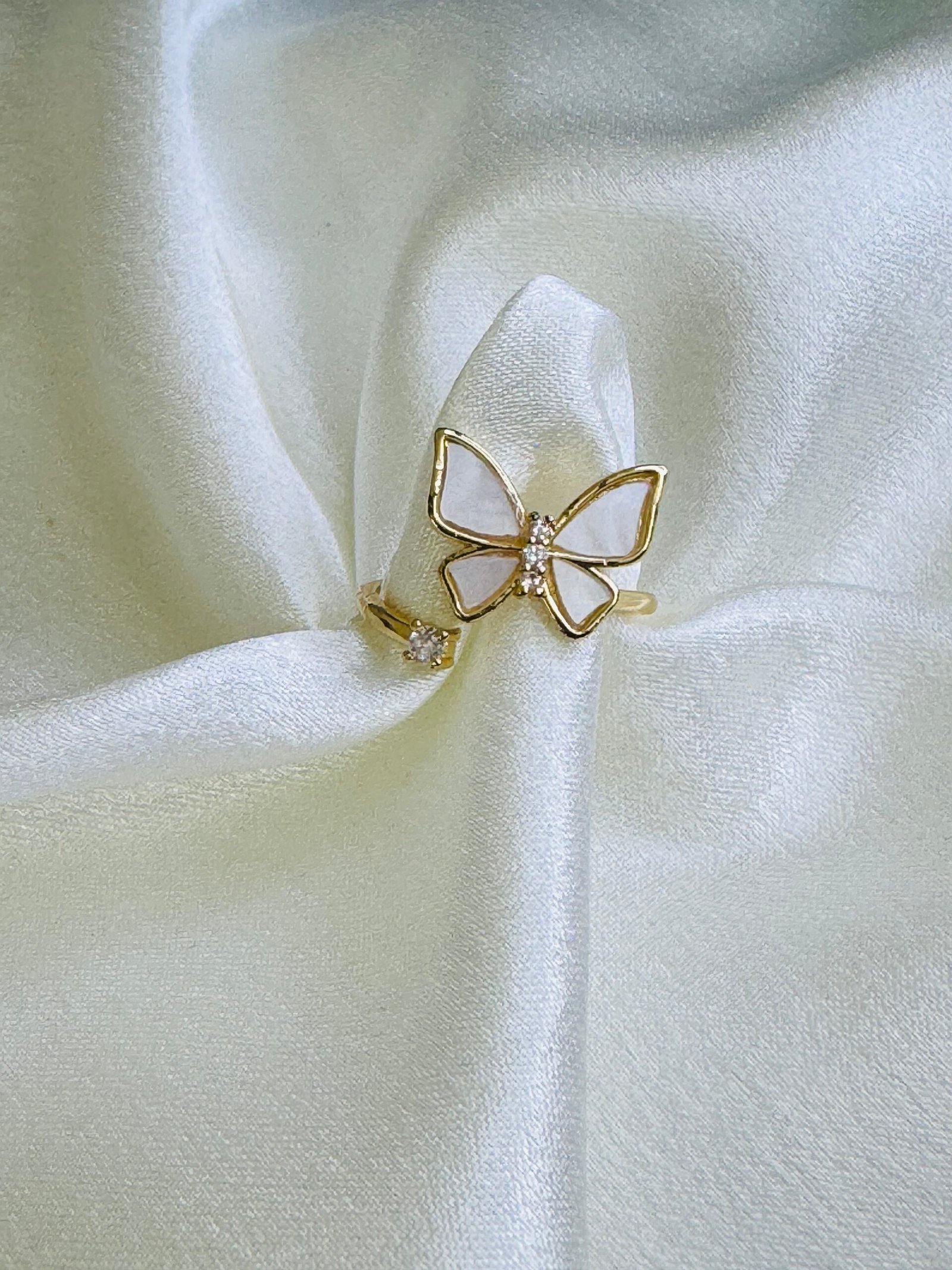 Adjustable open butterfly ring with gold plating, white enamel or mother-of-pearl wings, and cubic zirconia accents. - Image 3