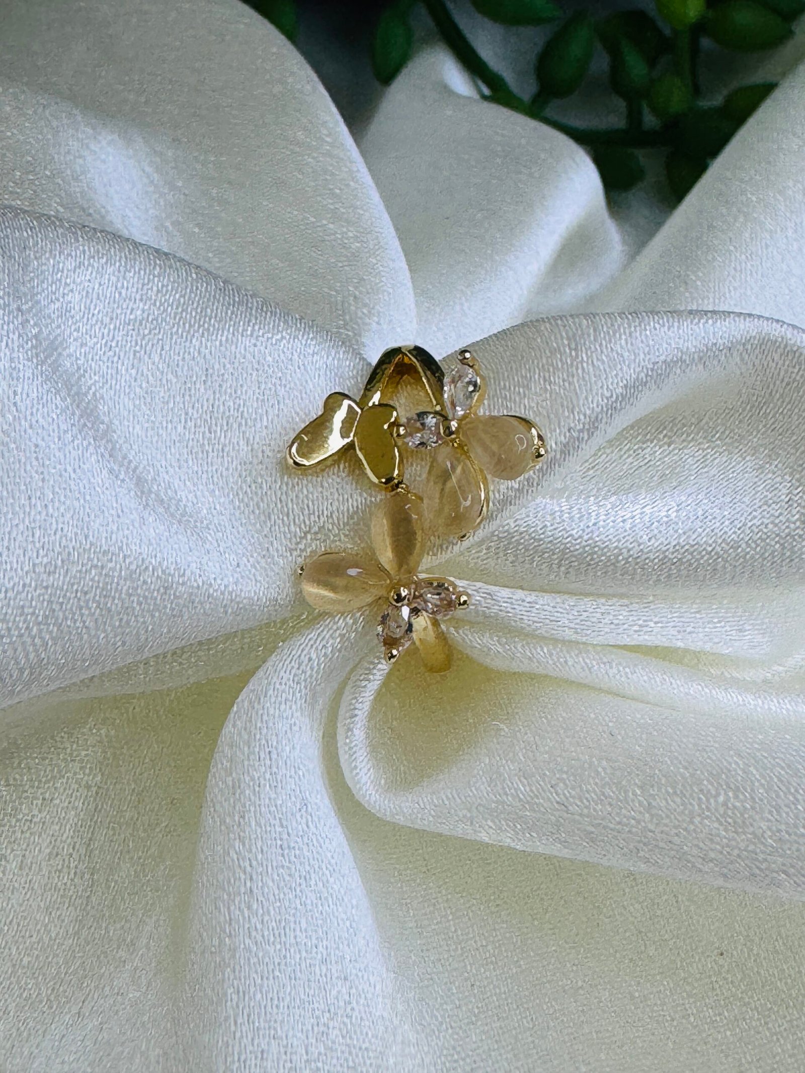 Adjustable gold-plated finger ring with opal-style flower and zirconia accents. 299/-