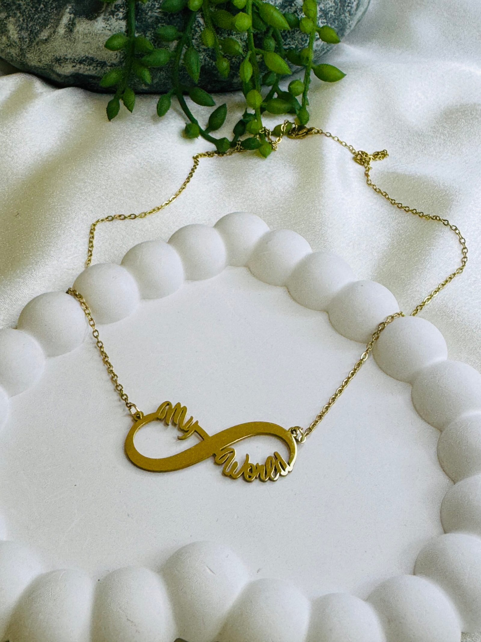 Gold-Plated personalized infinity pendant necklace with the words "my world" scripted on it.