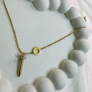 gold-toned-pendant-necklace-with-a-nail-shaped-charm-and-a-small-accent-stone