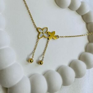 gold-plated Rommanel chain with a flower and butterfly design featuring a crystal and shell details.