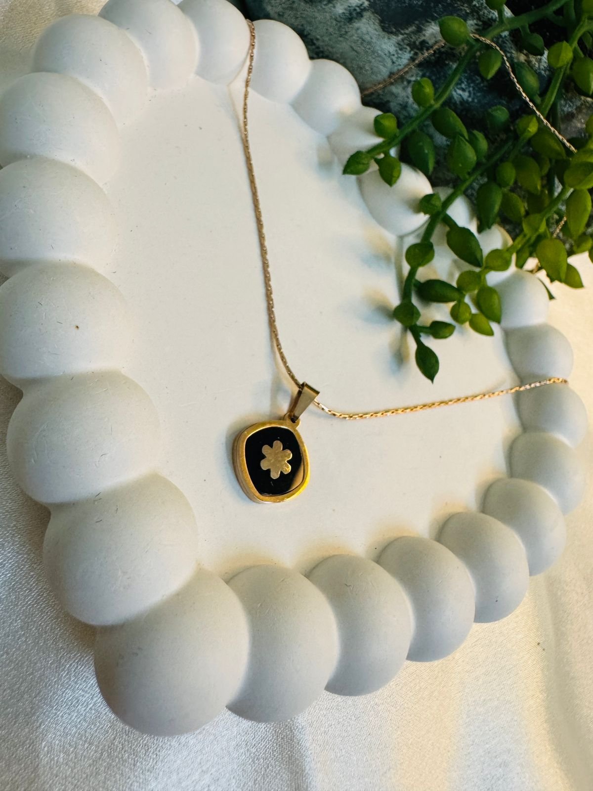 Rose gold-plated chain with a black and white clover pendant. - Image 3