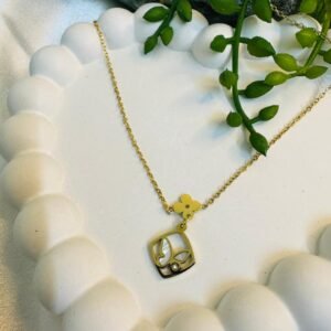 gold-toned necklace with a square butterfly and flower pendant.