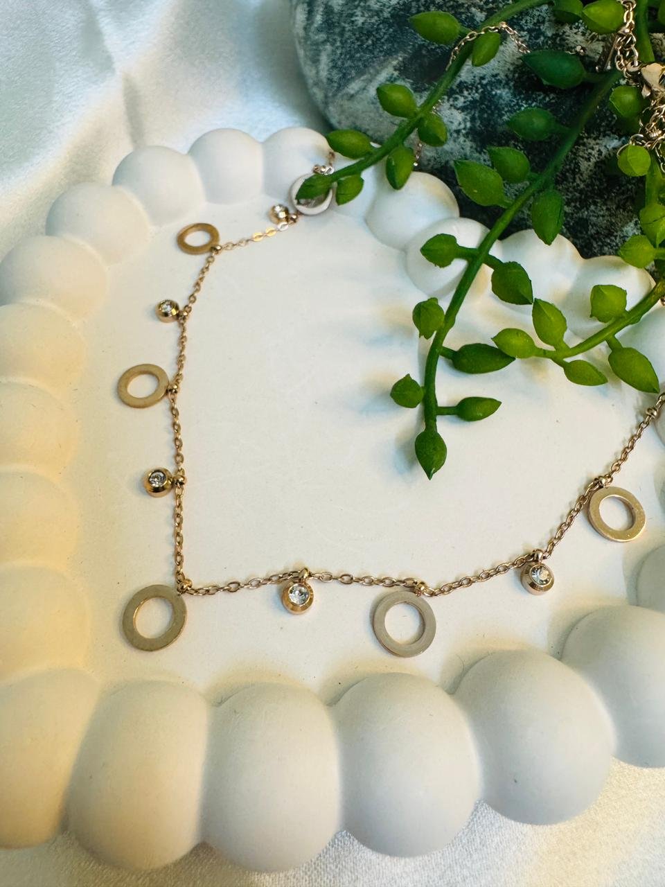 Rose gold-tone chain featuring circular links and cubic zirconia stones. - Image 3