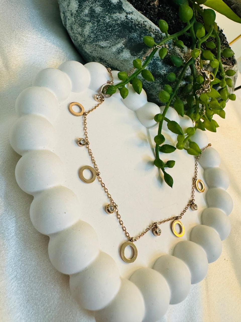 Rose gold-tone chain featuring circular links and cubic zirconia stones. - Image 2