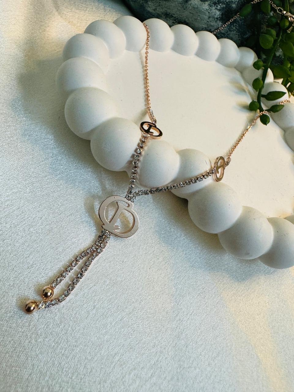 rose gold-plated, cubic zirconia-encrusted lariat-style pendant necklace featuring a prominent "D" motif. - Image 3