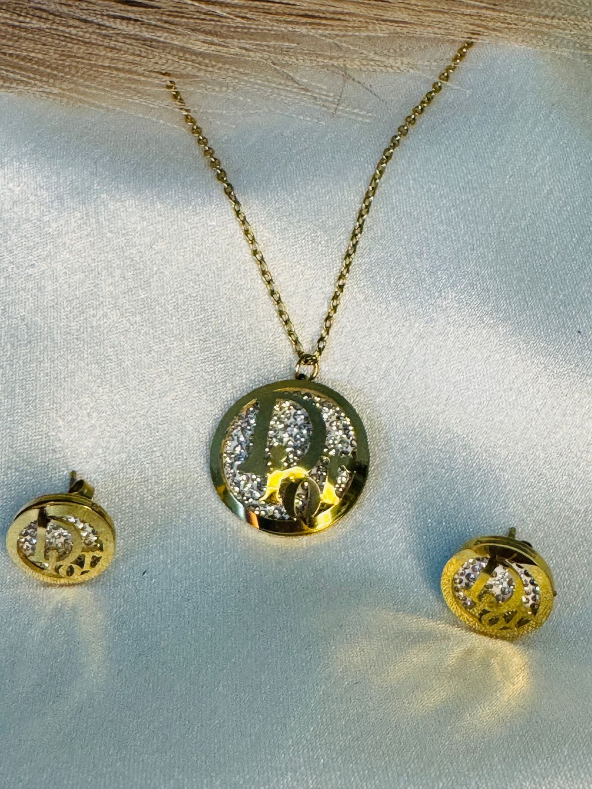 Gold-toned initial pendant necklace and matching stud earrings set with crystal embellishments. - Image 3