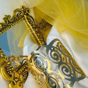 gold-toned-metal-napkin-ring-with-a-cut-out-swirl-design