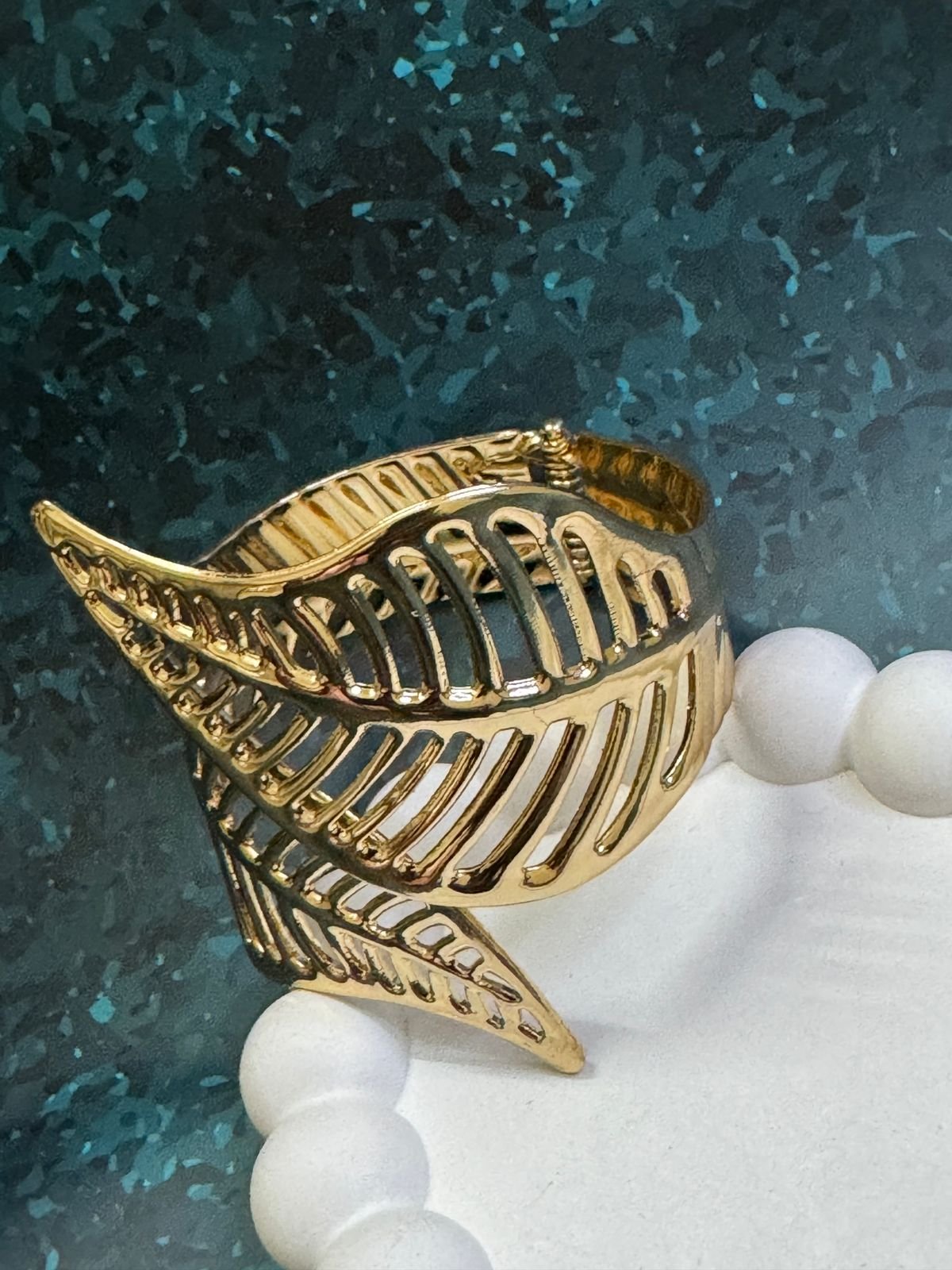 Nature-inspired, high-polish 18K gold-plated leaf cuff bracelet with an open, flexible design.
