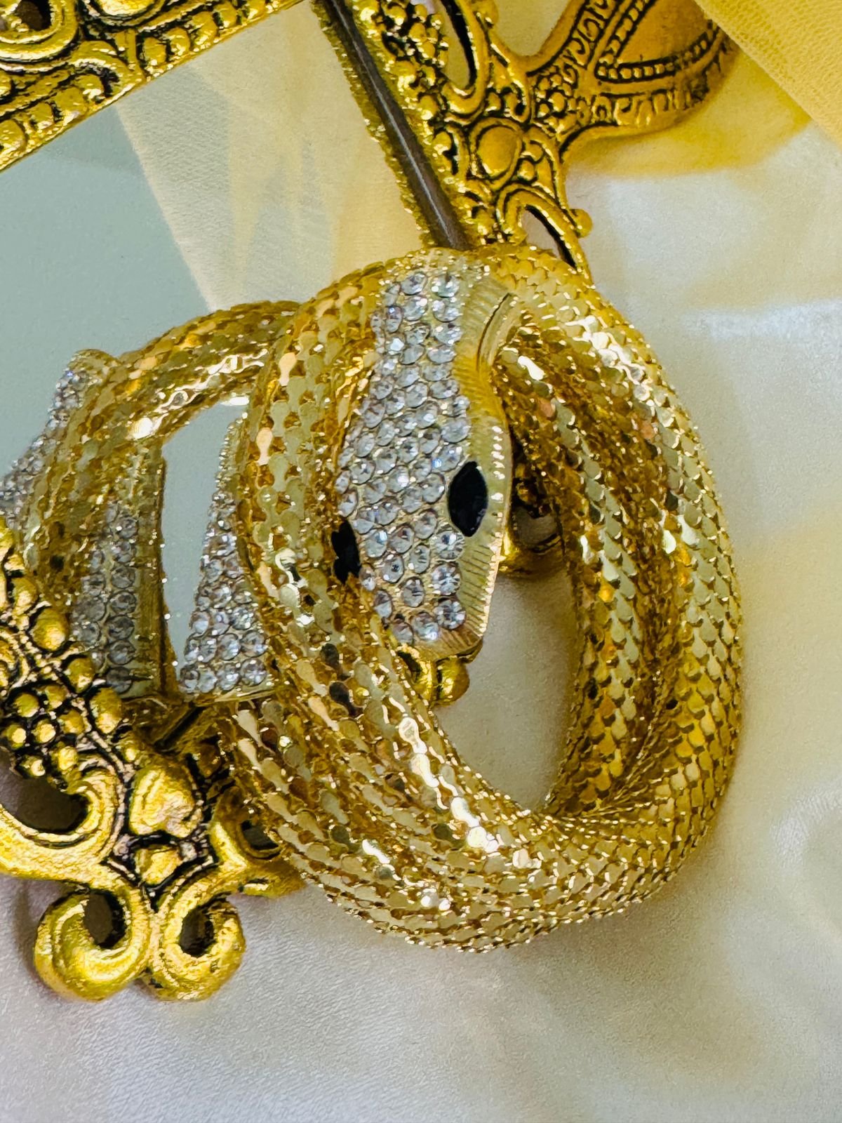 Gold-plated rhinestone snake cuff bracelet.