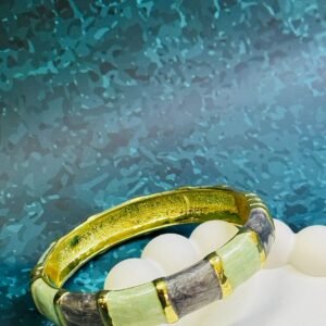 fashion-bangle-bracelet-featuring-an-enamel-finish-in-mint-green-and-grey-colors-with-gold-tone-accents-and-a-hinged-closure