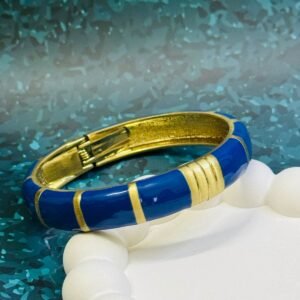 Gold-tone and navy blue enamel hinged bangle bracelet.