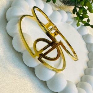 a-double-band-cuff-or-hinged-bangle-with-an-h-initial-centerpiece-and-a-clasp-closure