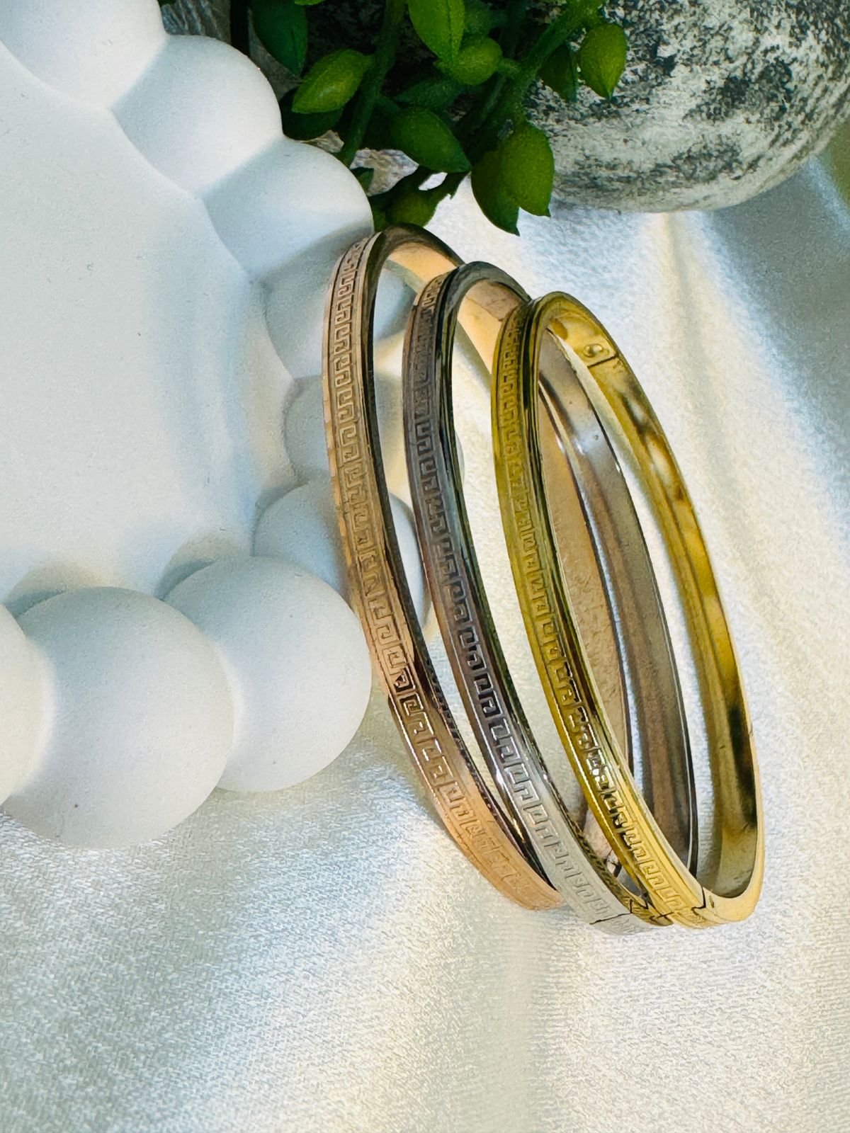 Three stainless steel greek key bangles/kadas in Rose gold, Silver, and Gold tones.