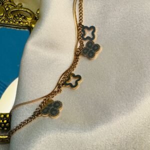 Rose gold-plated titanium steel double-layer clover charm bracelet.